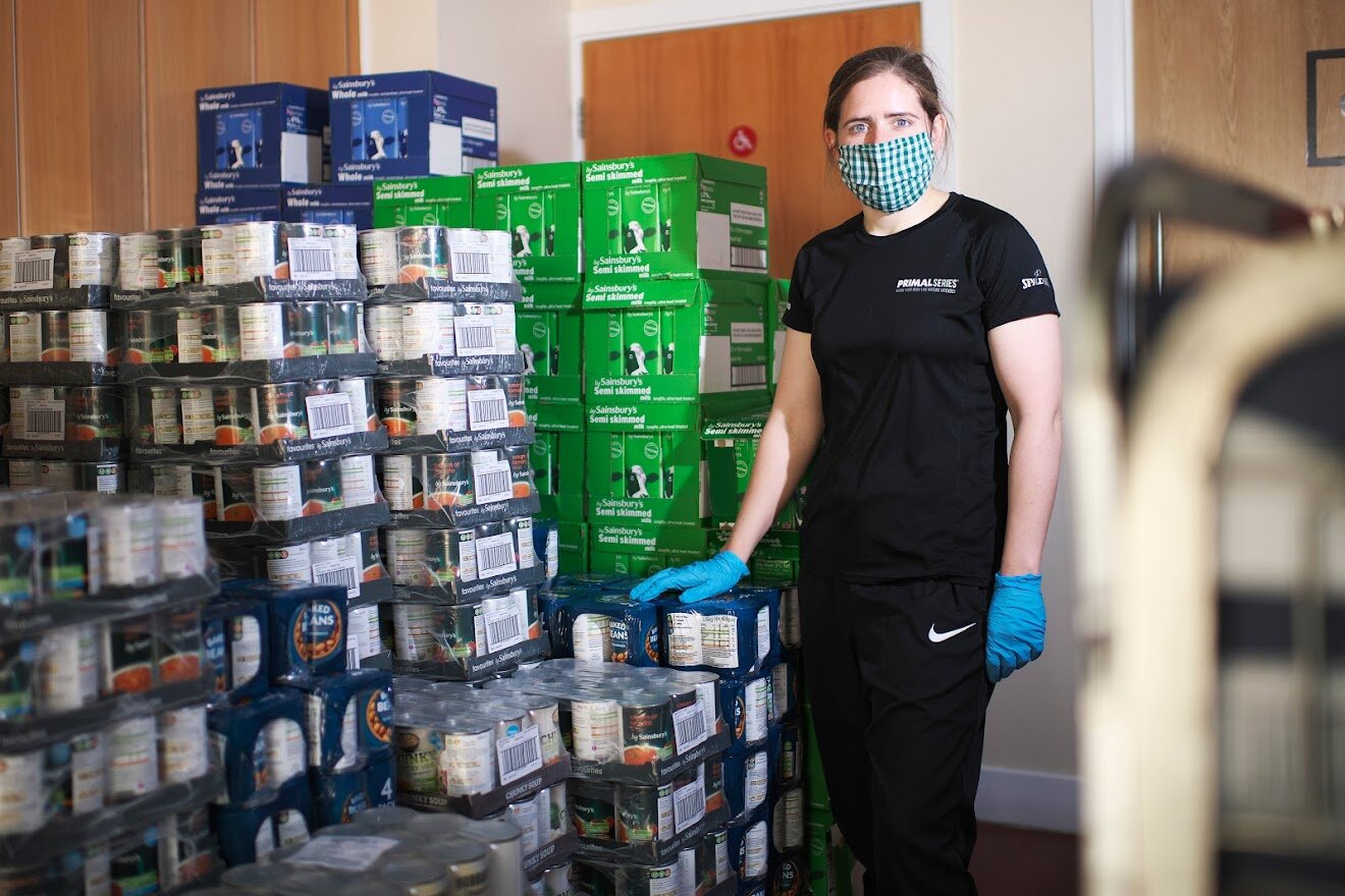 Georgia and Age UK Camden colleagues pack food parcels for distribution to older people